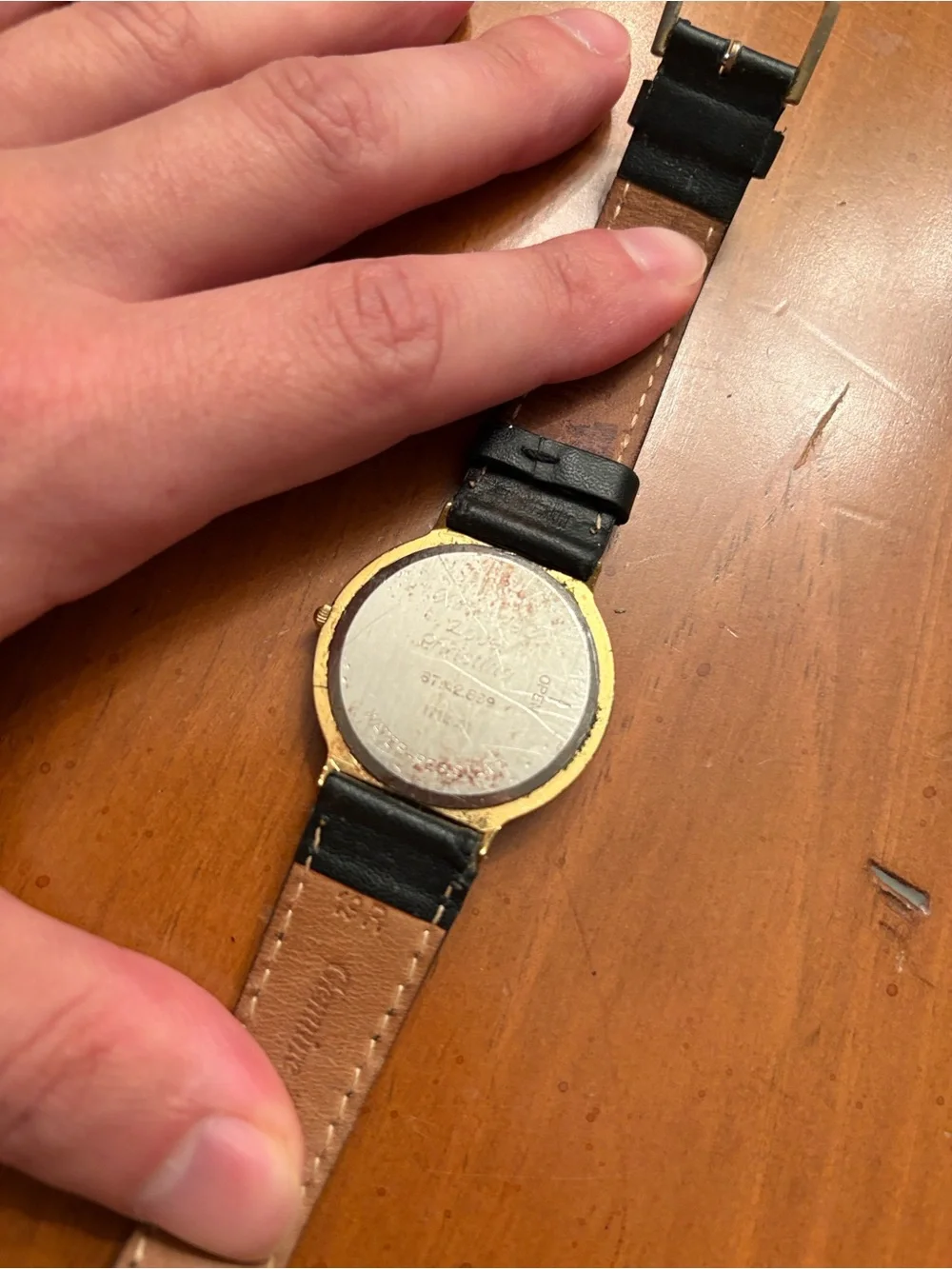Movado Gold Dial Watch with Black Leather Strap
